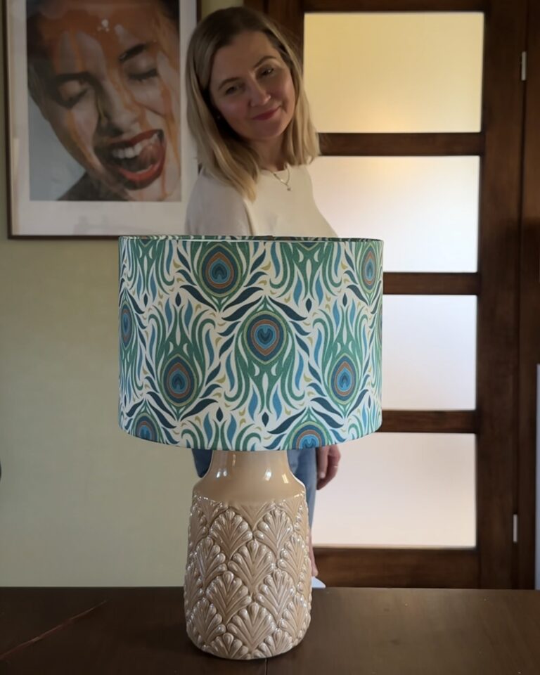 Elegant handmade Art Deco Peacock Table Lamp with teal and blue lampshade, captured in natural light.